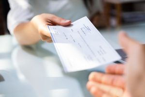 handing over a business check