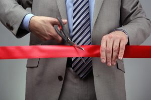 man cutting through the red tape