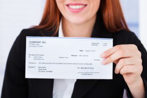 woman holding a business check