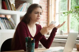 frustrated woman having problem with mobile deposit